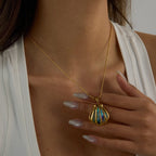 Gold necklace with a colorful pendant worn by a person