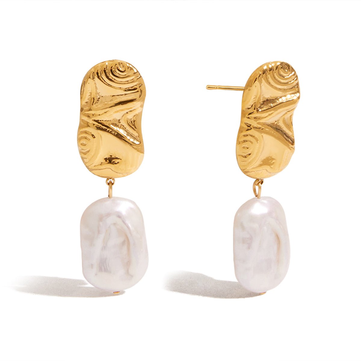 Gold earrings with white pearl drops on a white background
