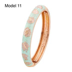 Gold enamel bangle featuring red rose patterns on turquoise background