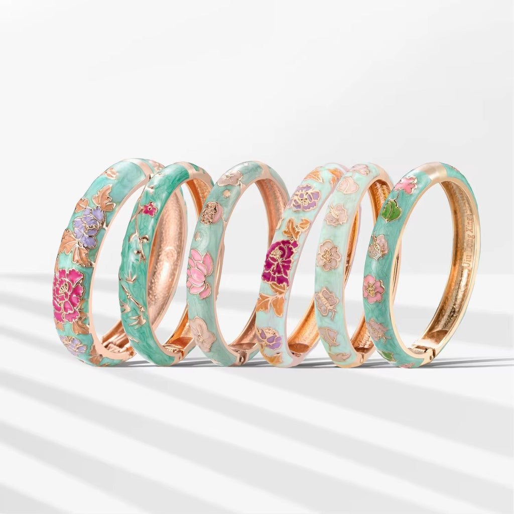 Set of floral-patterned bangles with gold accents on a white background