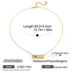 Gold necklace with blue heart pendant and measurement details on a white background