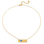 Gold necklace with a heart-shaped pendant on a white background
