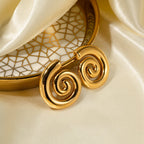 Gold bracelet with intricate design on a beige fabric background