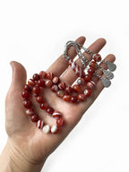 Close-up of natural brown agate beads on handcrafted Islamic tasbih