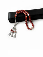 Side view of misbaha with earthy-tone agate stones for spiritual balance