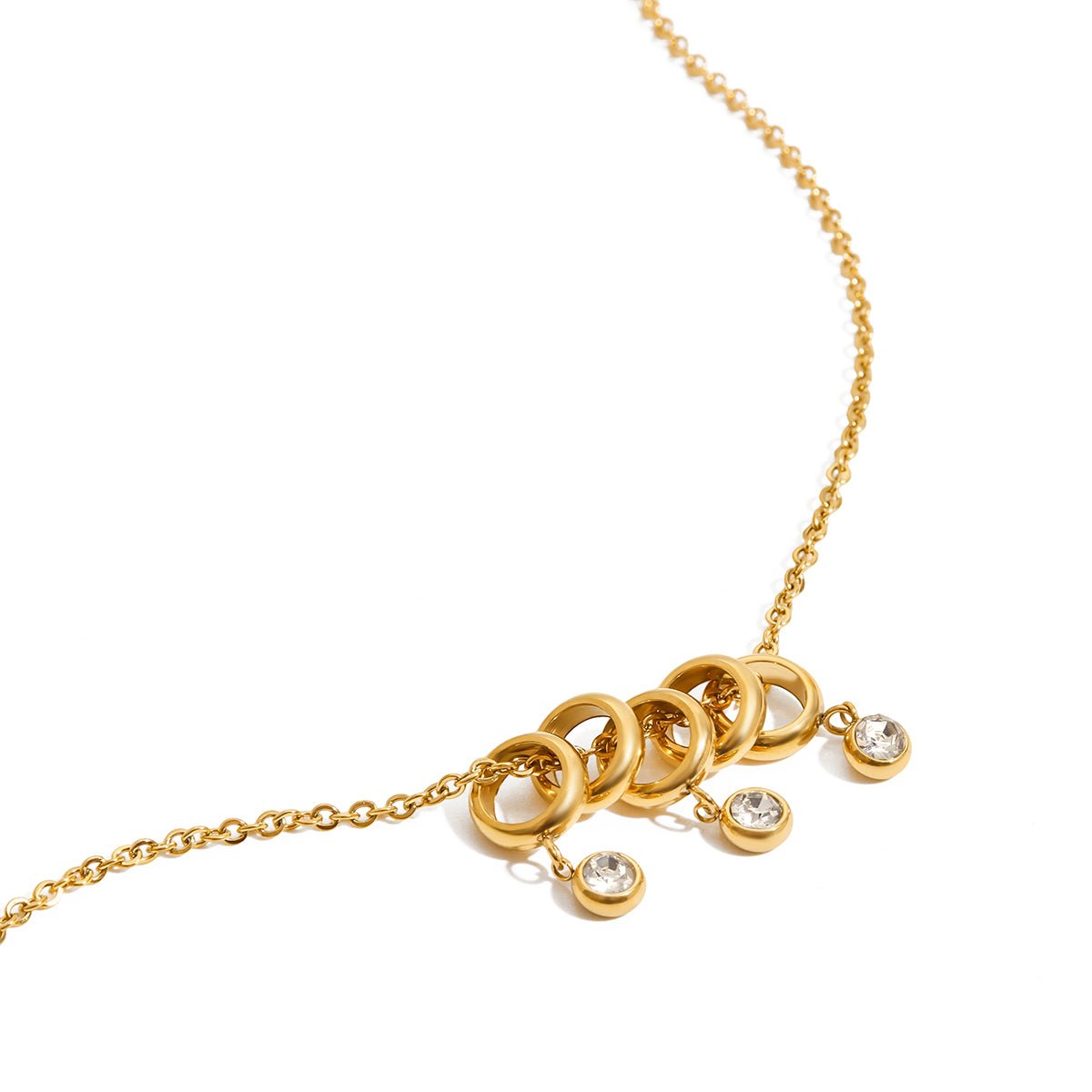 Gold necklace with circular pendants and small diamonds on a white background