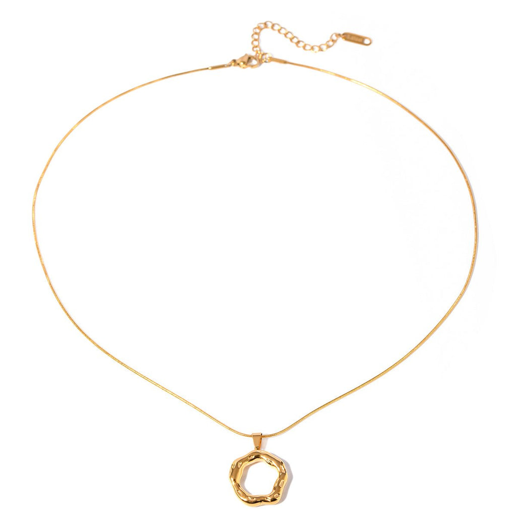 Gold necklace with a unique pendant on a white background