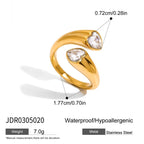 Gold ring with heart-shaped gemstones and measurements on a white background