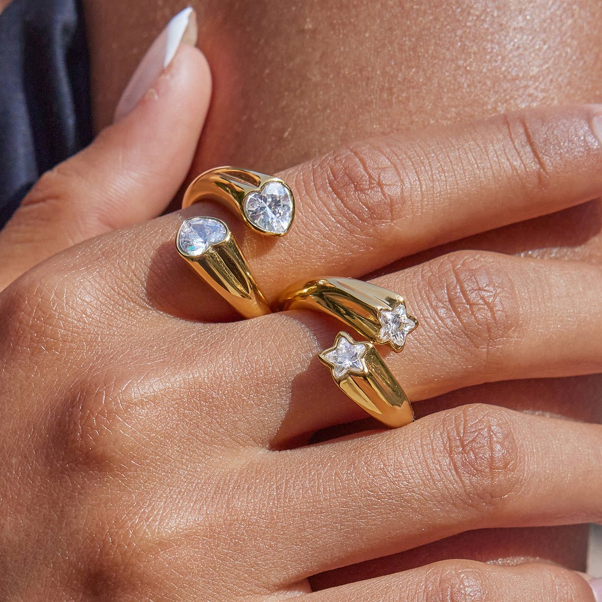 Gold rings with gemstones on a hand