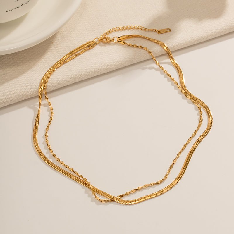 Gold necklace on a beige fabric background
