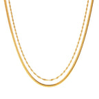 Two gold necklaces on a white background