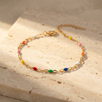 Tarnish-free 316L stainless steel bracelet showcasing a sequence of white orange pink yellow red and green beads.