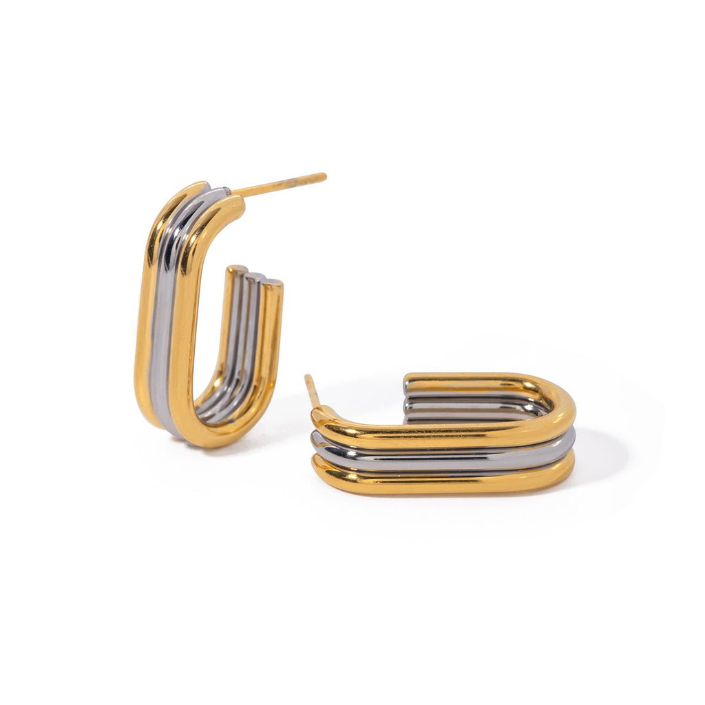 Gold and silver hoop earrings on a white background