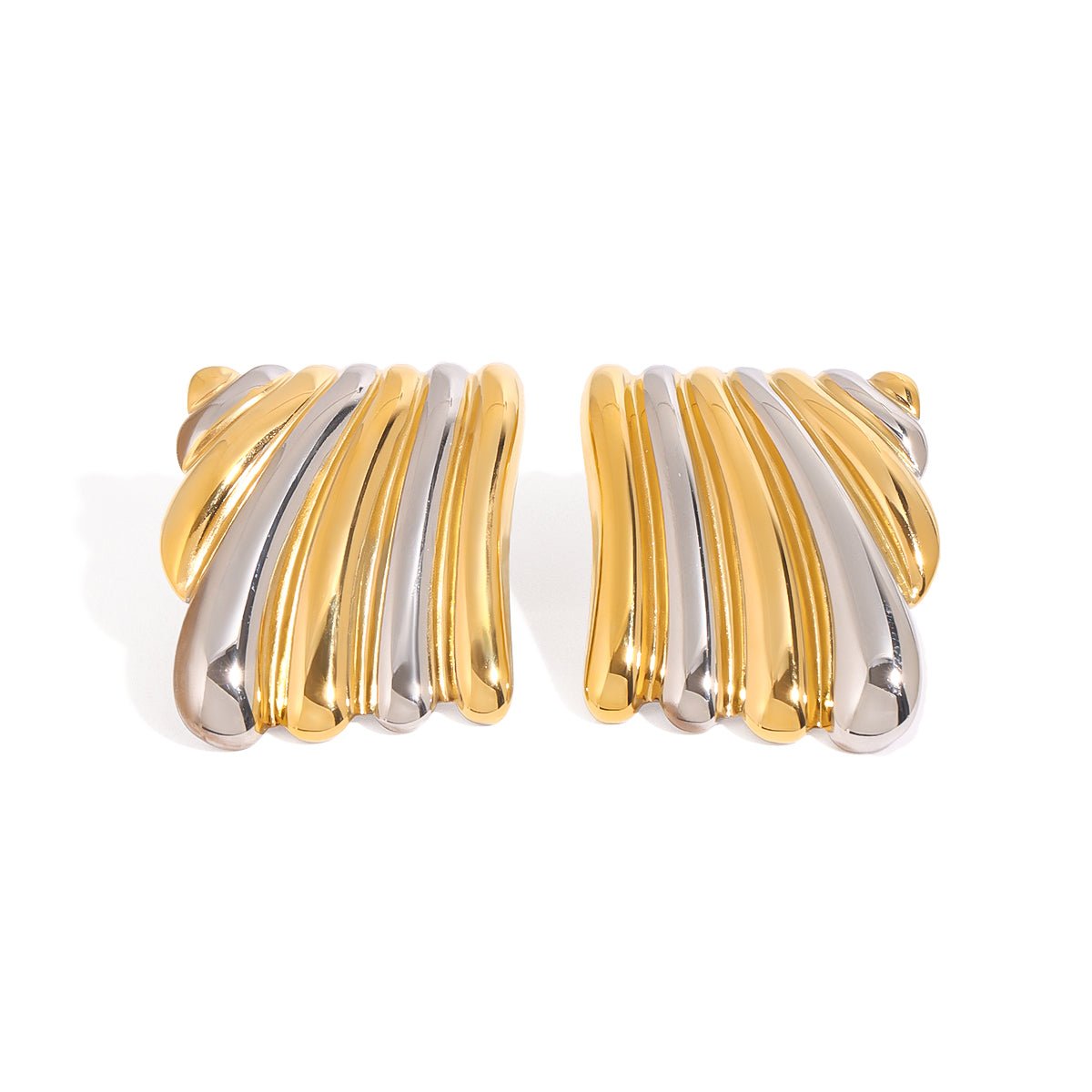 Pair of gold and silver earrings on a white background