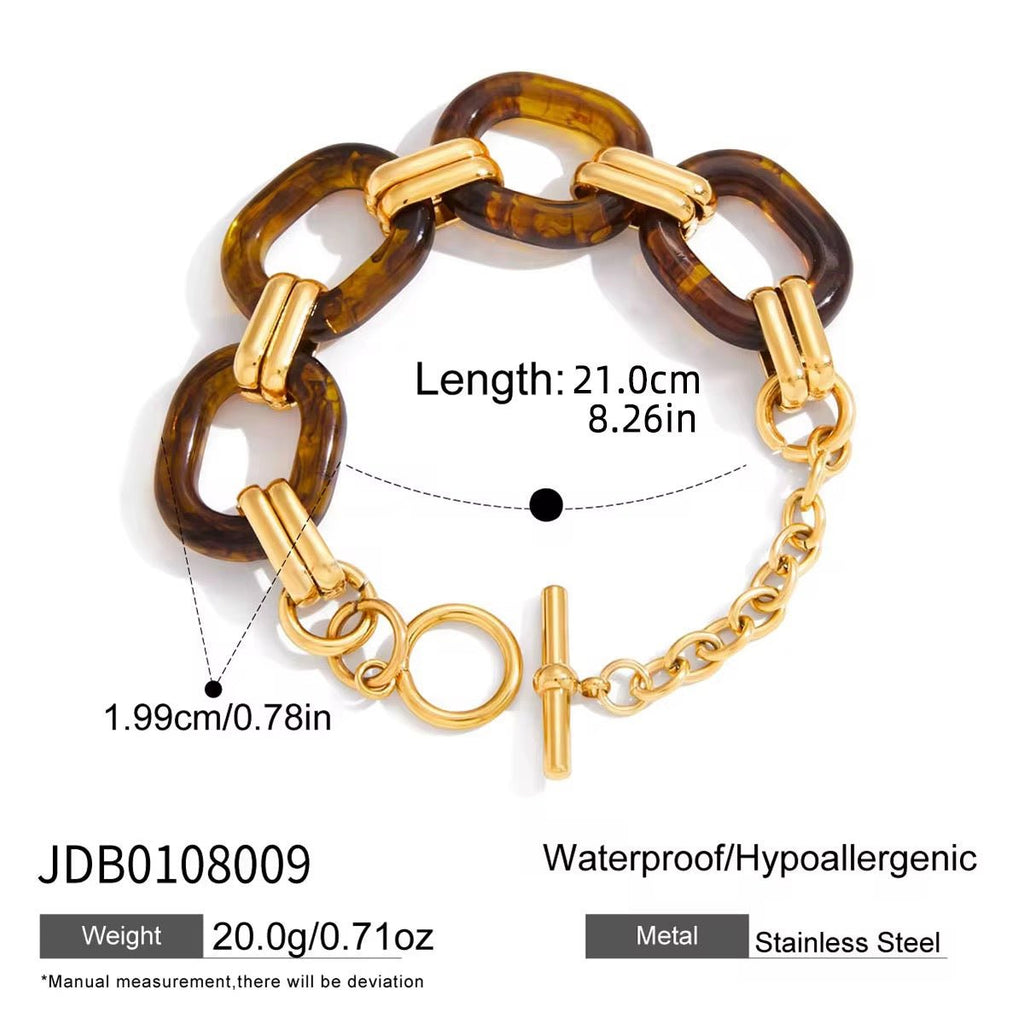 Bracelet with tortoiseshell and gold links on a white background