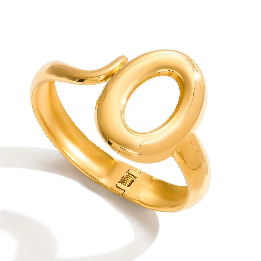 Gold ring with a unique design on a white background