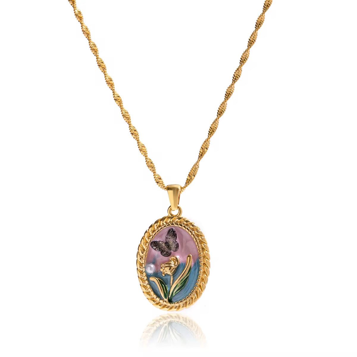 Gold necklace with a pendant featuring a floral design on a white background