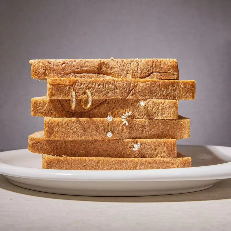 Stack of bread slices on a white plate with a gray background