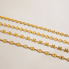Three gold chains of different designs on a light gray background