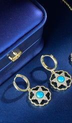 Close-up of Firooza turquoise earrings in elegant blue box