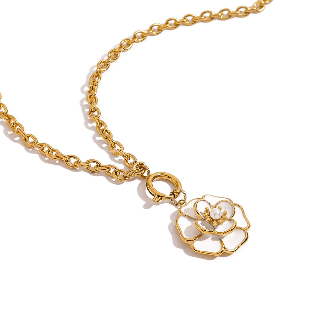 Gold chain necklace with a floral pendant on a white background