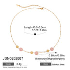 Gold necklace with floral elements on a white background, showing measurements and material details.