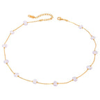 Gold necklace with pearls on a white background