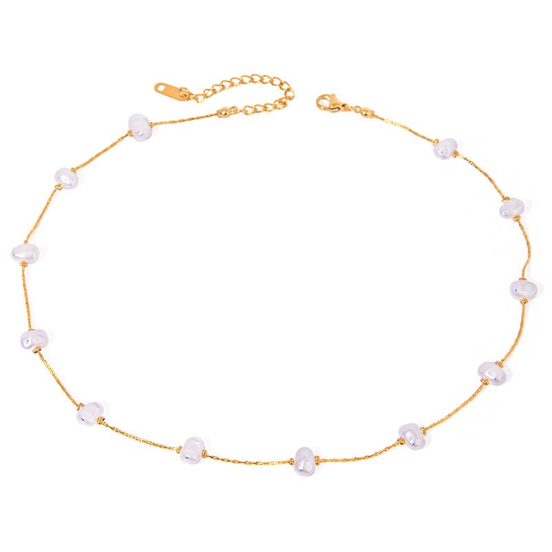 Gold necklace with pearls on a white background