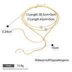 Gold necklace with measurements on a white background