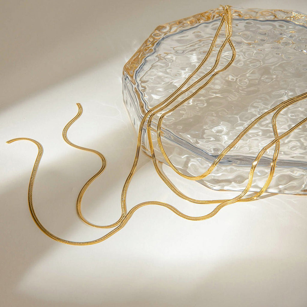 Clear glass dish with gold decorative elements on a light background