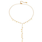 Gold necklace with small droplet pendants on a white background