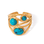 Gold bracelet with turquoise stones on a white background