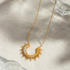 Gold necklace with a unique pendant on a light background