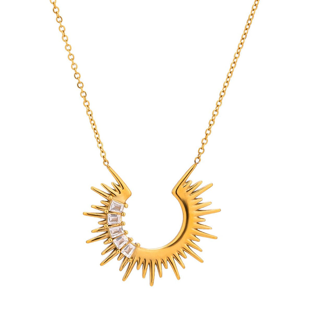 Gold necklace with a sunburst design on a white background