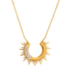 Gold necklace with a sunburst design on a white background