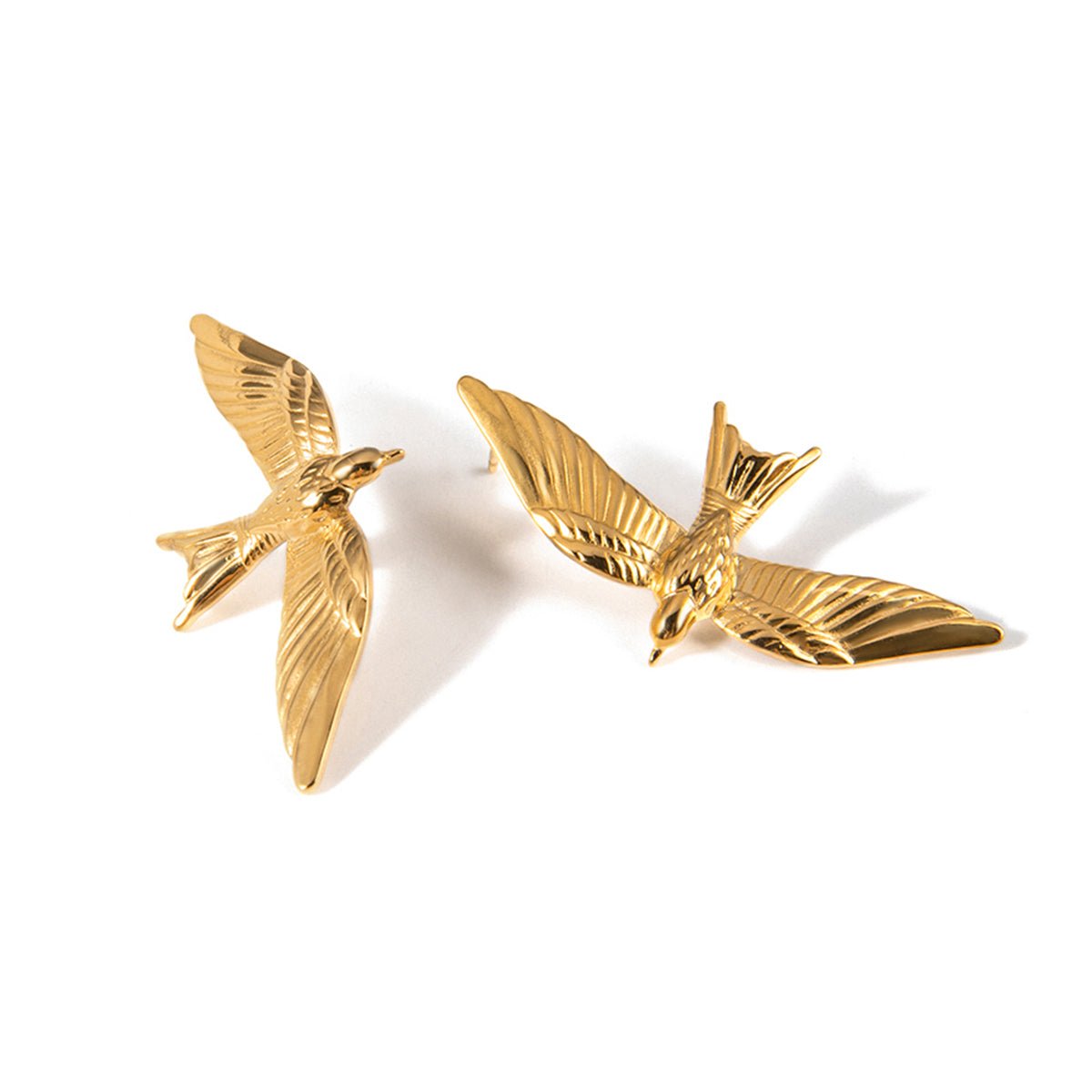 Gold bird-shaped earrings on a white background