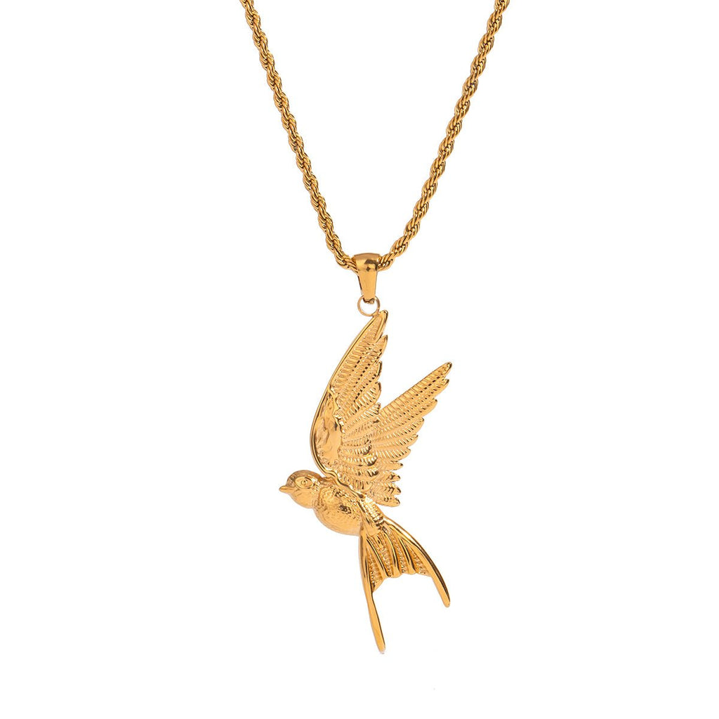 Gold bird pendant on a chain against a white background