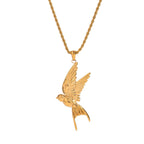 Gold bird pendant on a chain against a white background