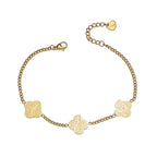 Gold bracelet with floral designs on a white background