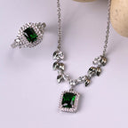 Emerald green and white CZ necklace and ring set - flat lay view