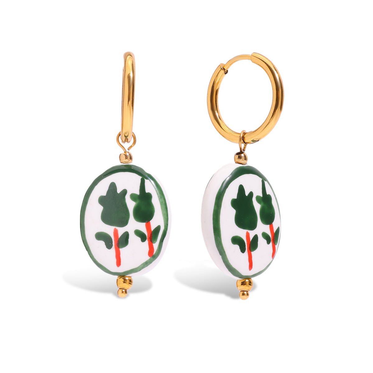 Pair of earrings with green and red designs on a white background