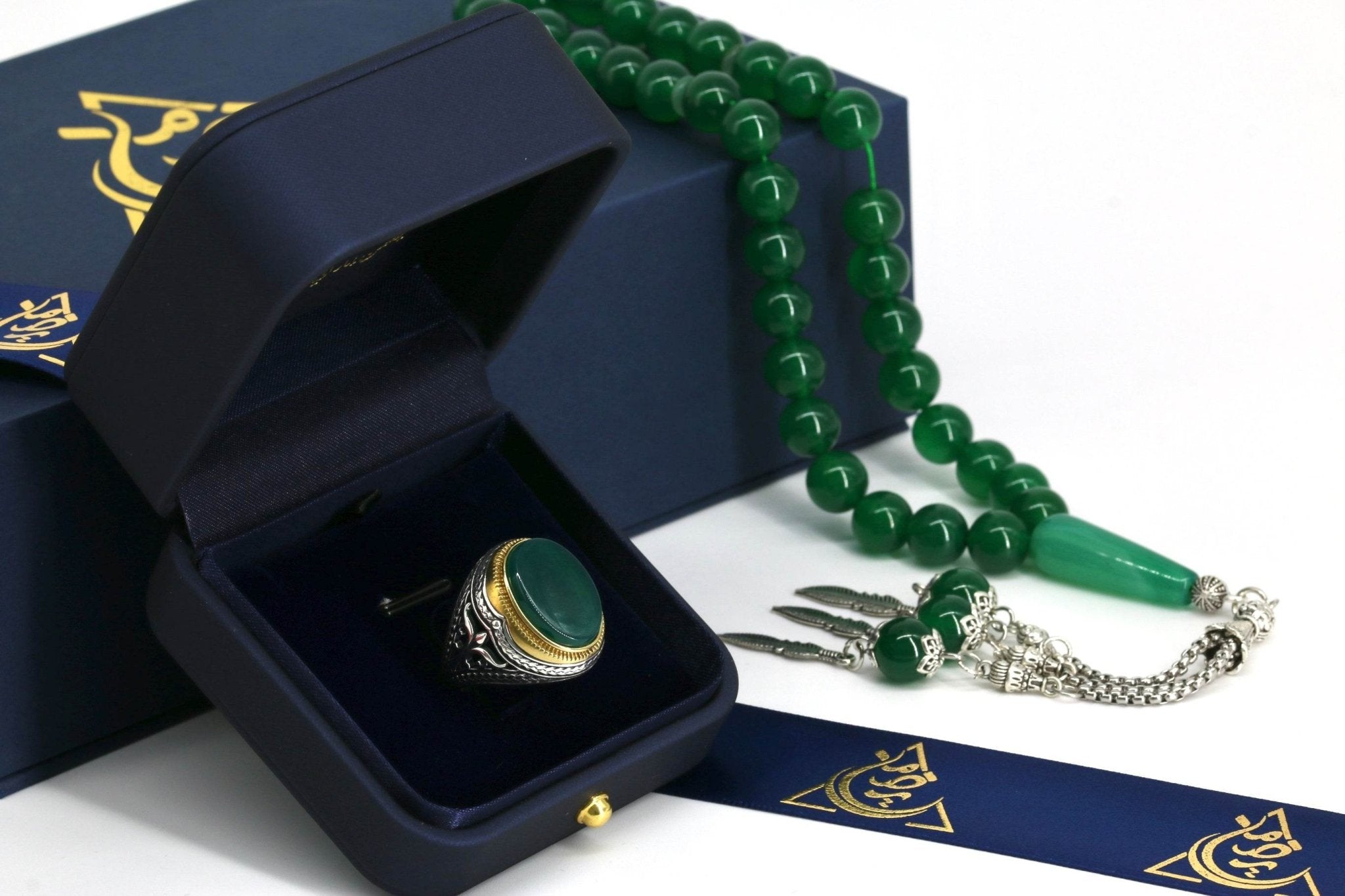 Side angle of handcrafted silver ring featuring a round green agate