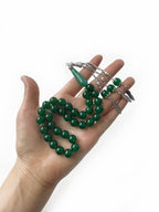 Close-up of vibrant green agate beads in a luxury 33-bead Emirati tasbih