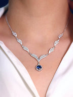 Elegant women’s necklace showcasing blue zirconia gemstone and leaf motif design