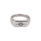Silver ring with a sun design on a white background