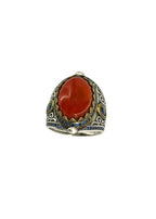 Close-up of handcrafted silver ring featuring a polished brown agate stone