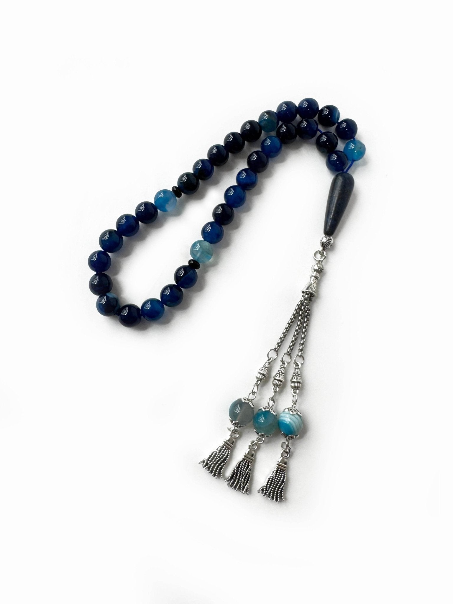 Detailed view of blue agate tasbih showing shine and traditional Emirati craftsmanship