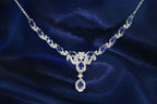 Women’s floral drop necklace featuring oval-cut blue sapphires and zirconia