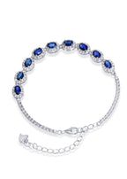 Close-up of sapphire statement ring and necklace in handcrafted silver design