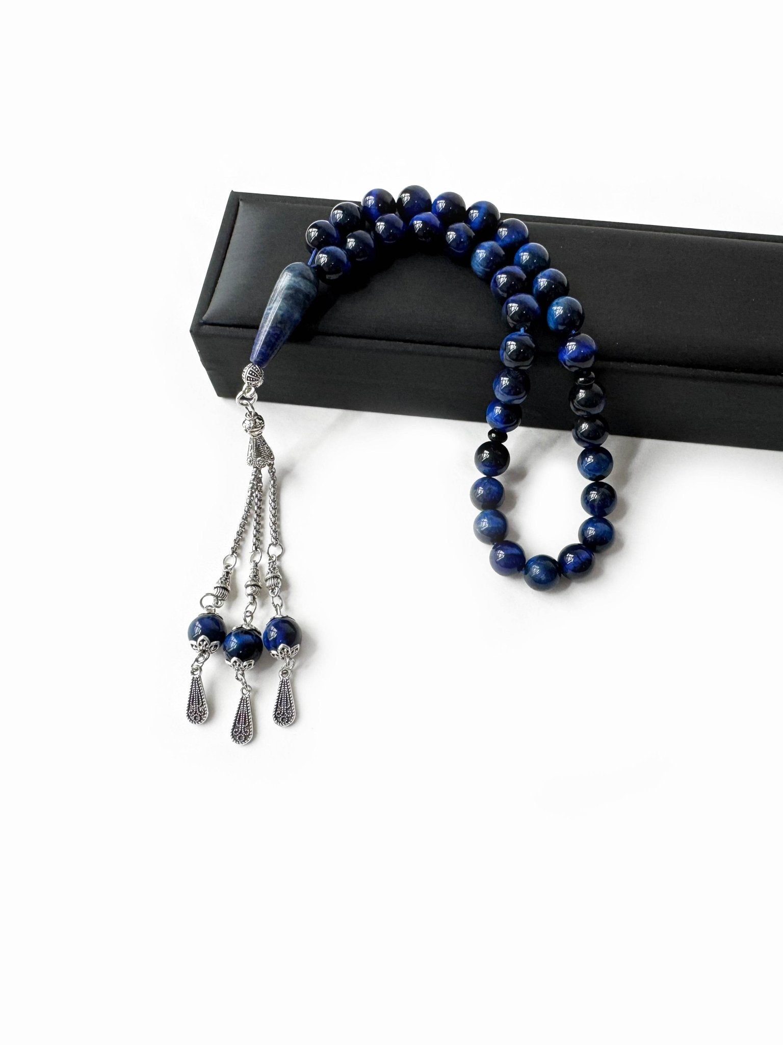 Side view of handcrafted tasbih featuring polished blue tiger eye stones